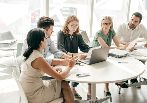 A group of work colleagues sat around a round table.